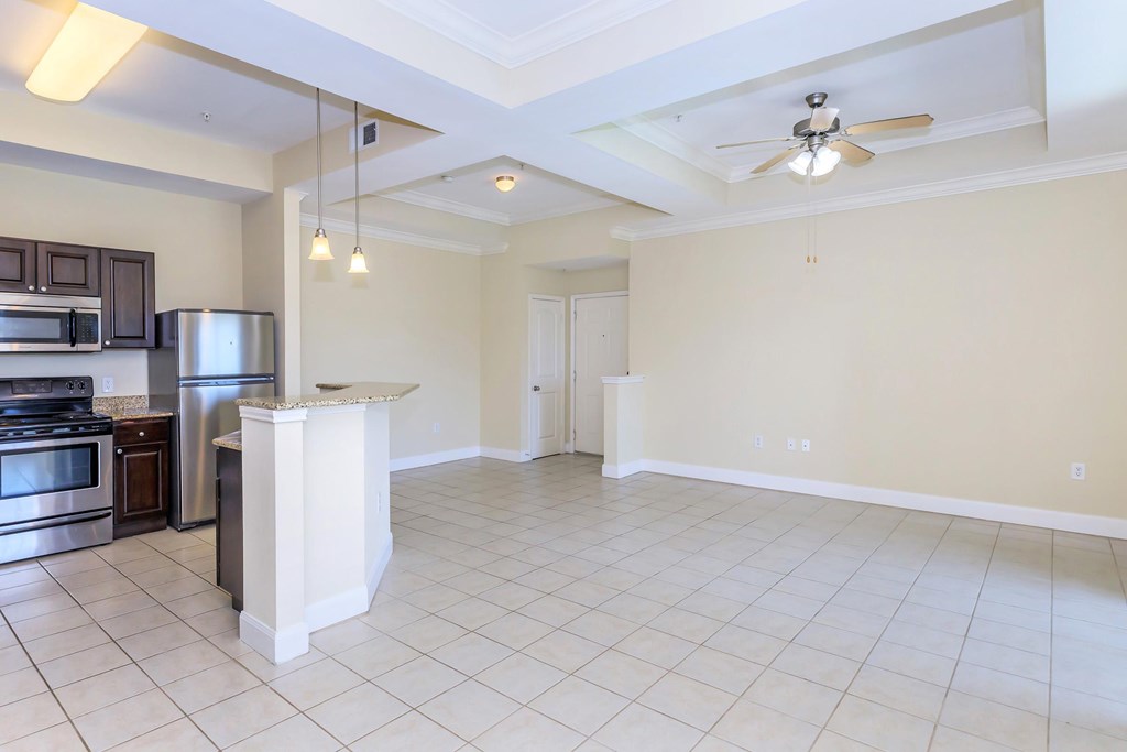 A kitchen with a stove top oven and a refrigerator.