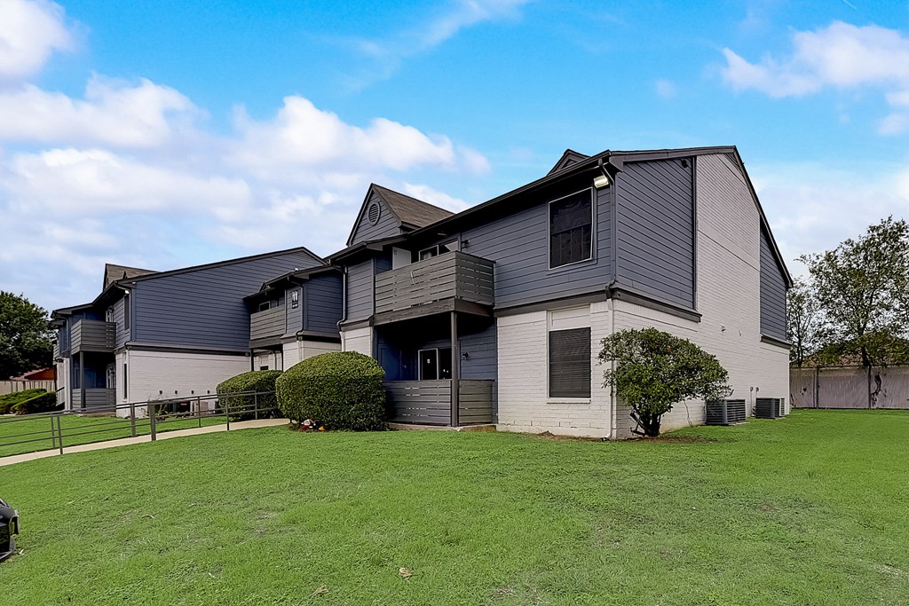 a large house with a yard in front of it