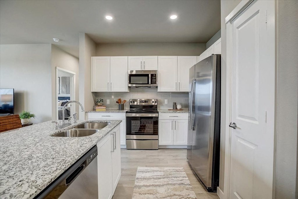 a kitchen with a sink and a refrigerator