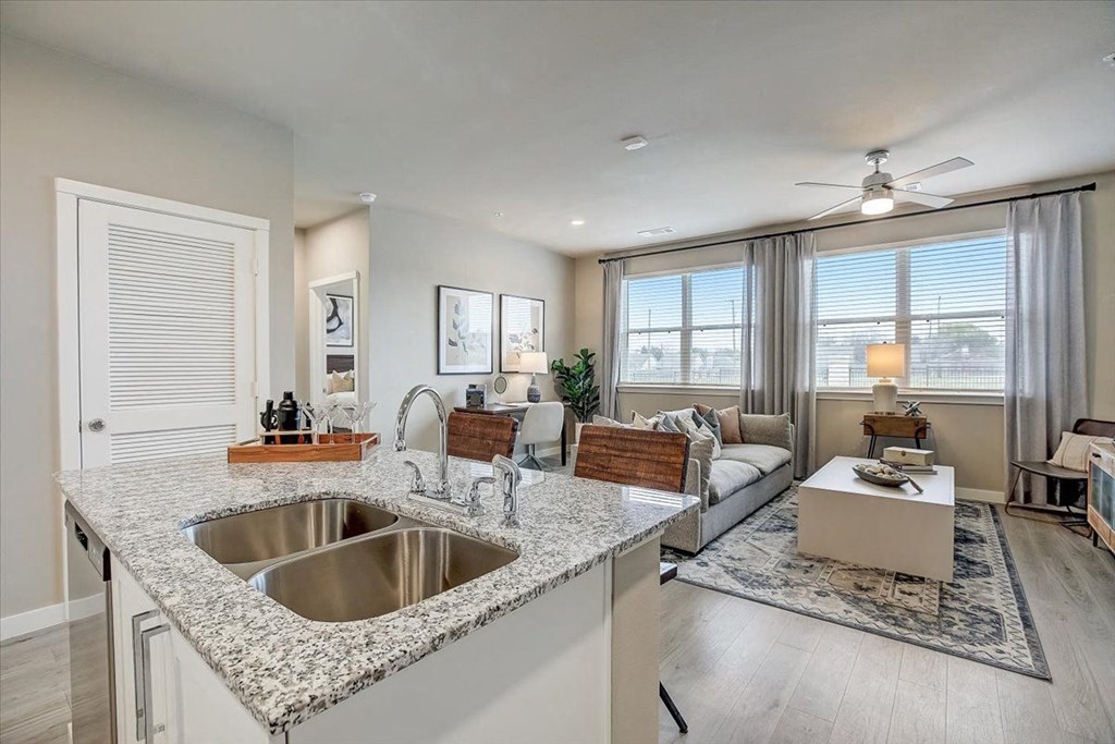 a kitchen with a sink and a counter top in a living room