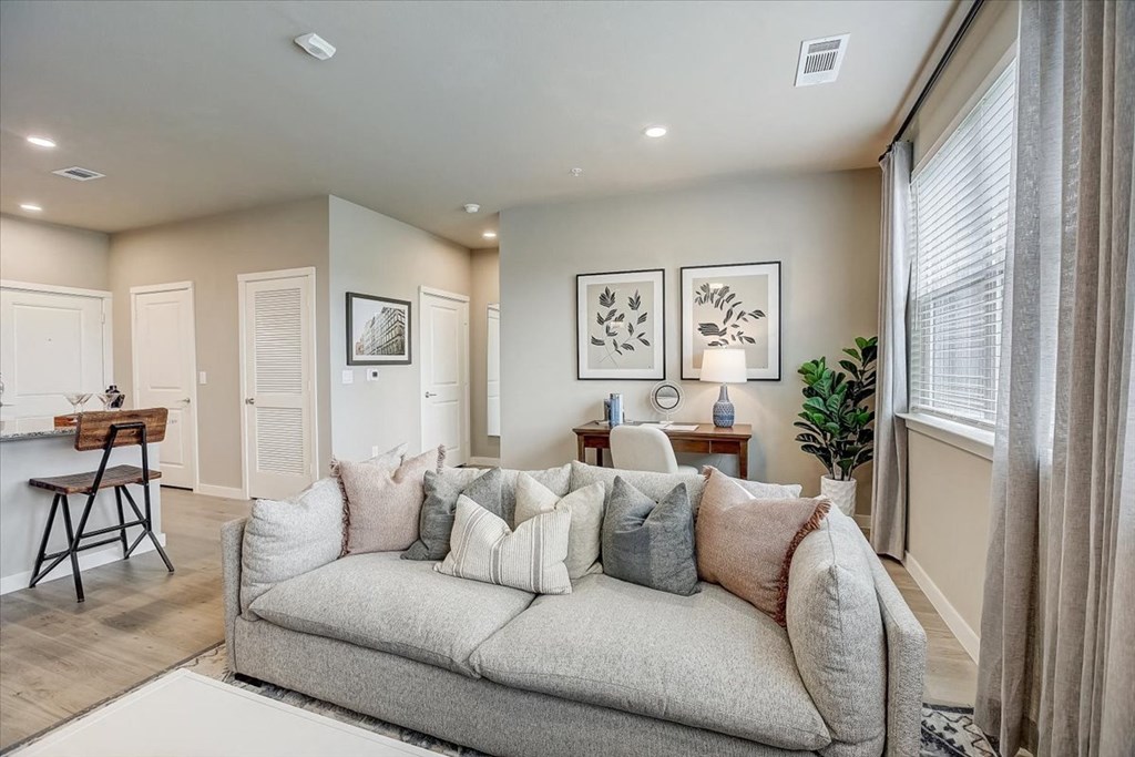 a living room with a couch and a dining room