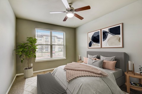 a bedroom with a large bed and a ceiling fan