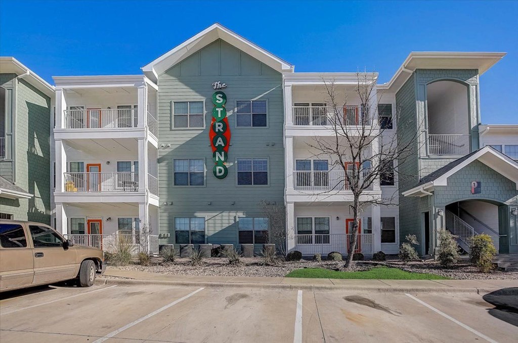 a large apartment building with a sign in front of it