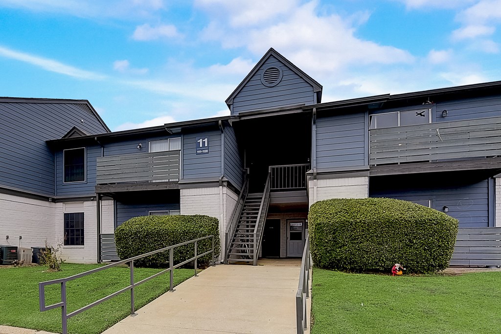 a blue and white building with a staircase in front of it