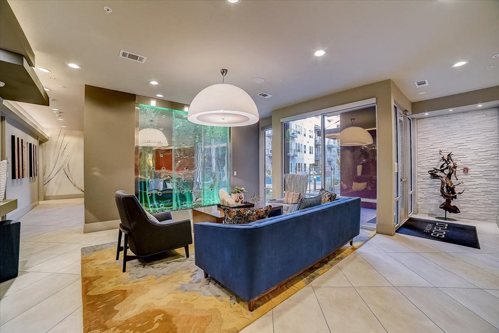 the lobby or reception area of a hotel with a blue reception desk