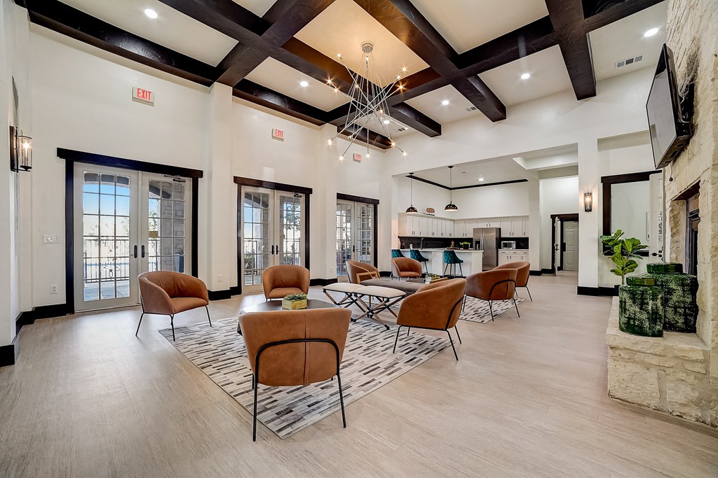 a lobby with chairs and tables and a fireplace