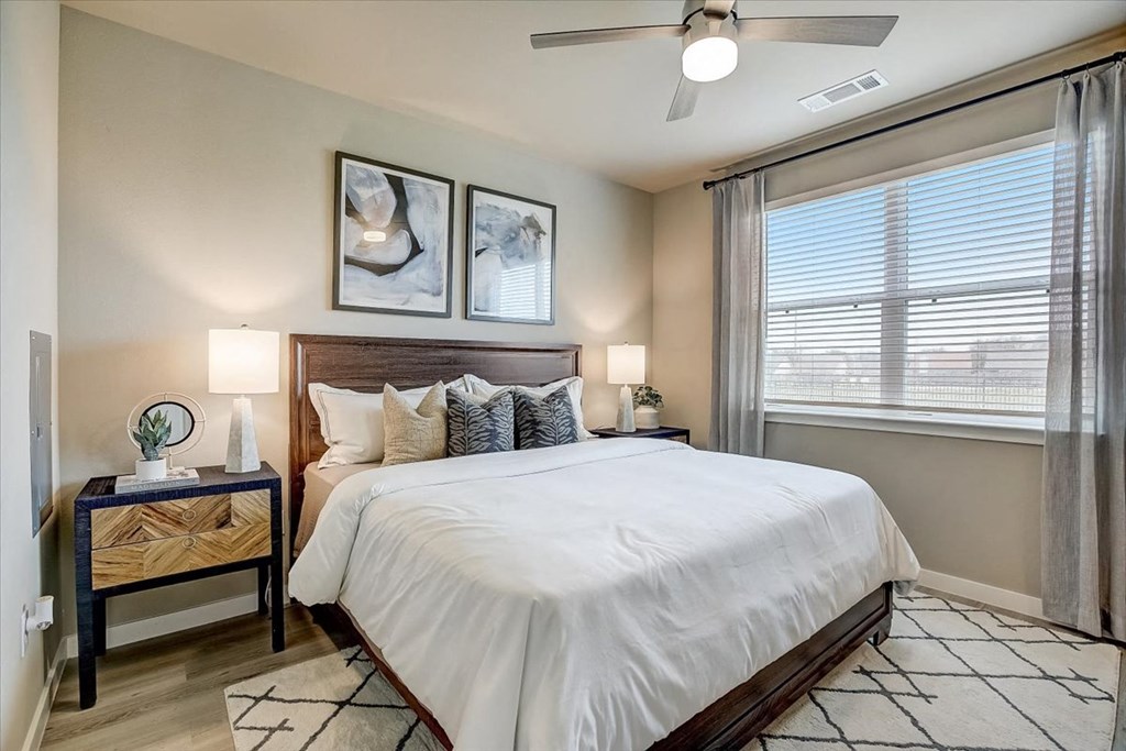 a bedroom with a bed and a ceiling fan
