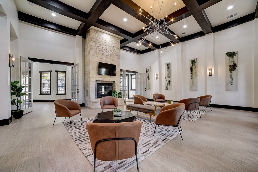 a living room with couches and chairs and a fireplace