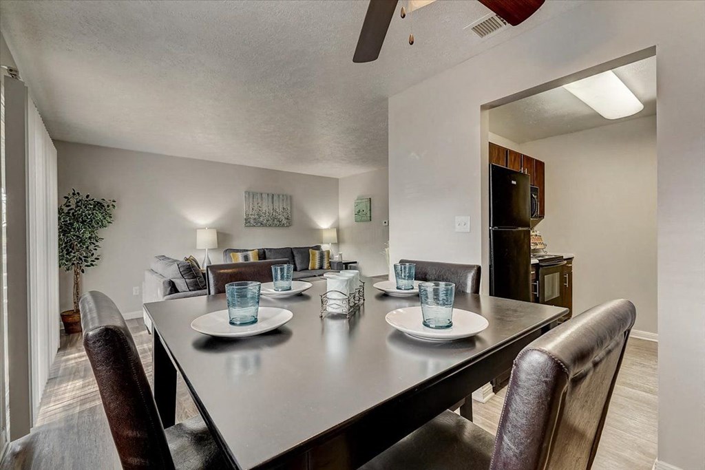 a dining room table with plates and glasses