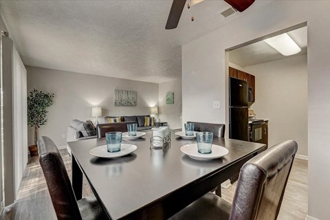 A dining room with a table set for two.