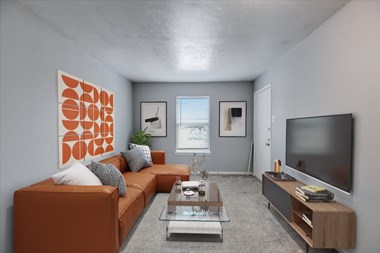 our apartments offer a living room with a couch coffee table and flat screen tv