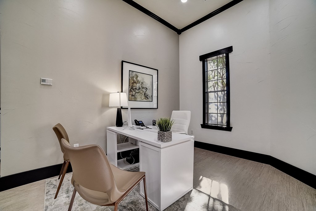 private office with white walls and a white desk with two chairs