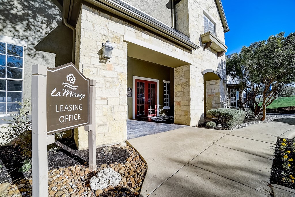 a building with a leasing office sign in front of it