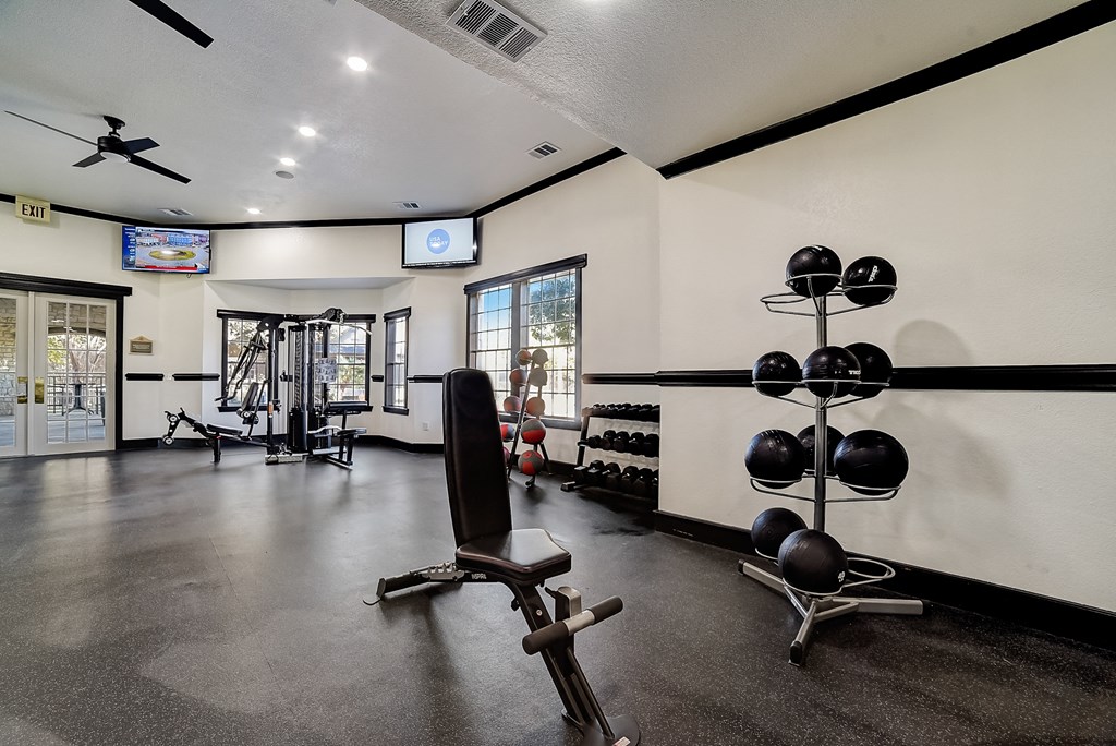 the gym with weights and cardio equipment at the oxford condos tx