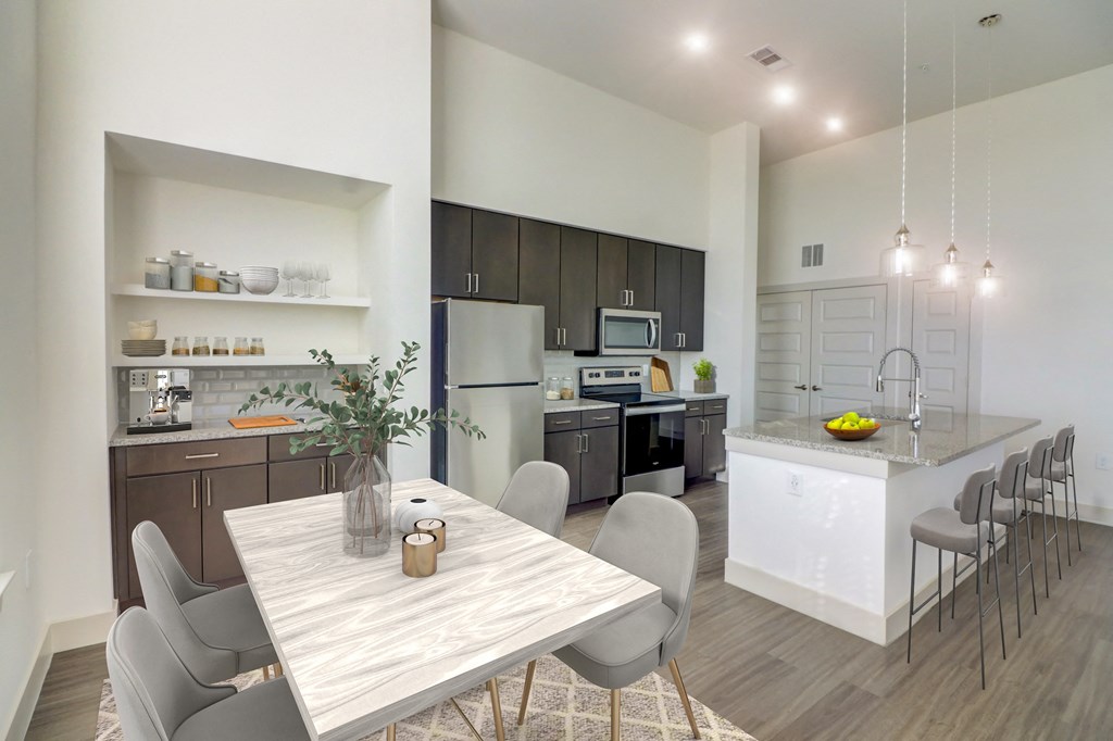 an open kitchen and dining room with a table and chairs