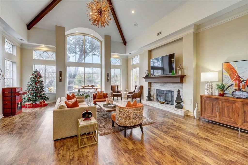 a living room with a fireplace and a christmas tree