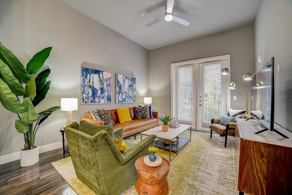 a living room with a couch and a ceiling fan