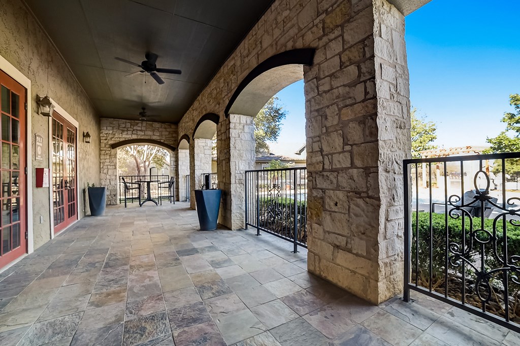 the preserve at ballantyne commons balcony with stone walls and a ceiling fan
