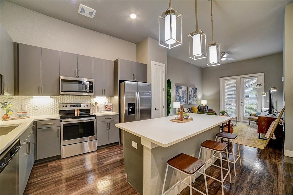 a kitchen with stainless steel appliances and a white counter top