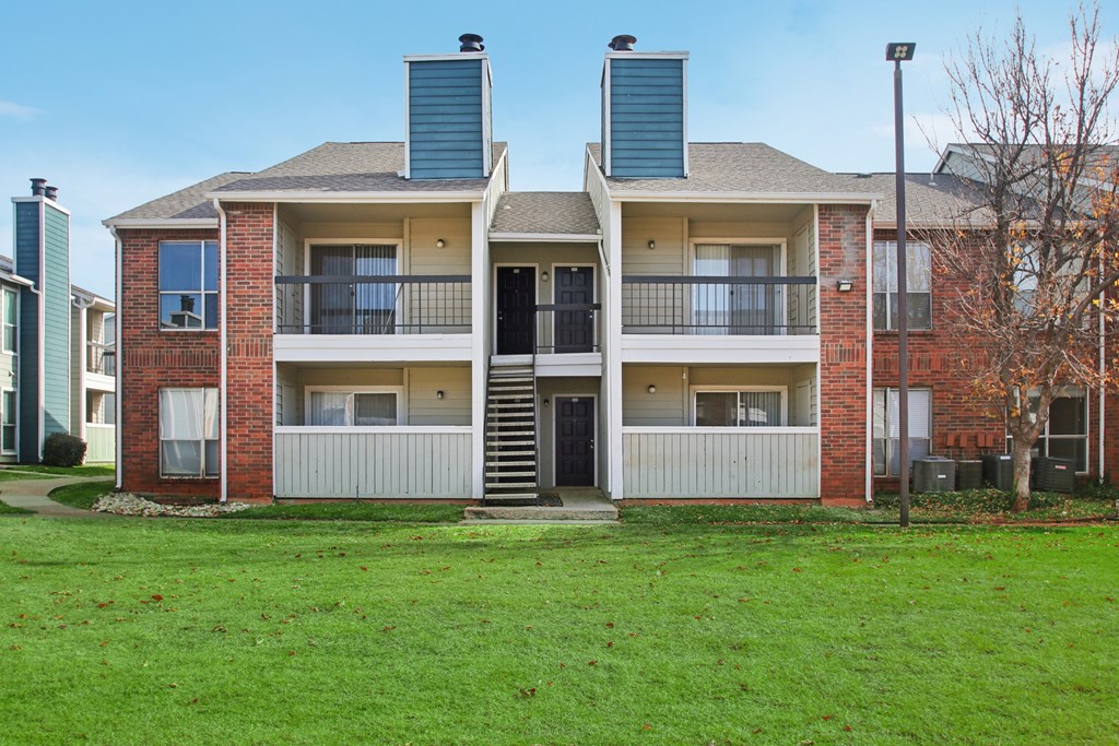 Apartment building with a green lawn in front.