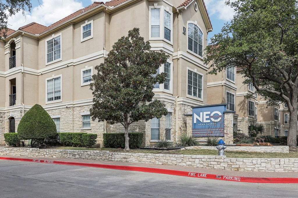 A building with the sign NEO in front of it.