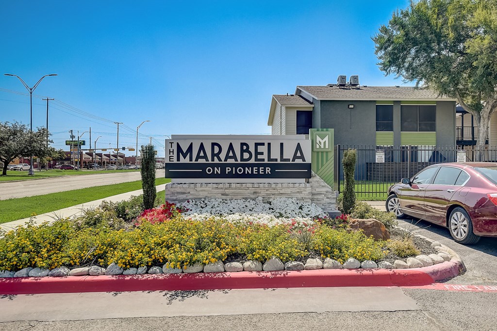 a car parked in front of a sign for marabella on pioneer