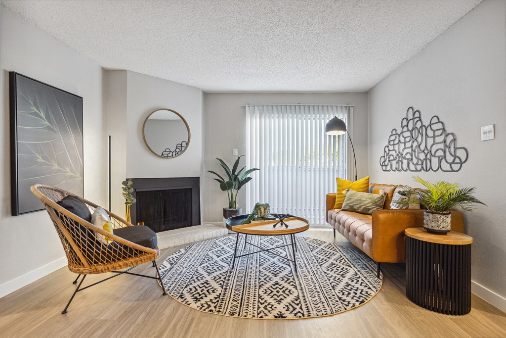 a living room with a brown couch and yellow pillows