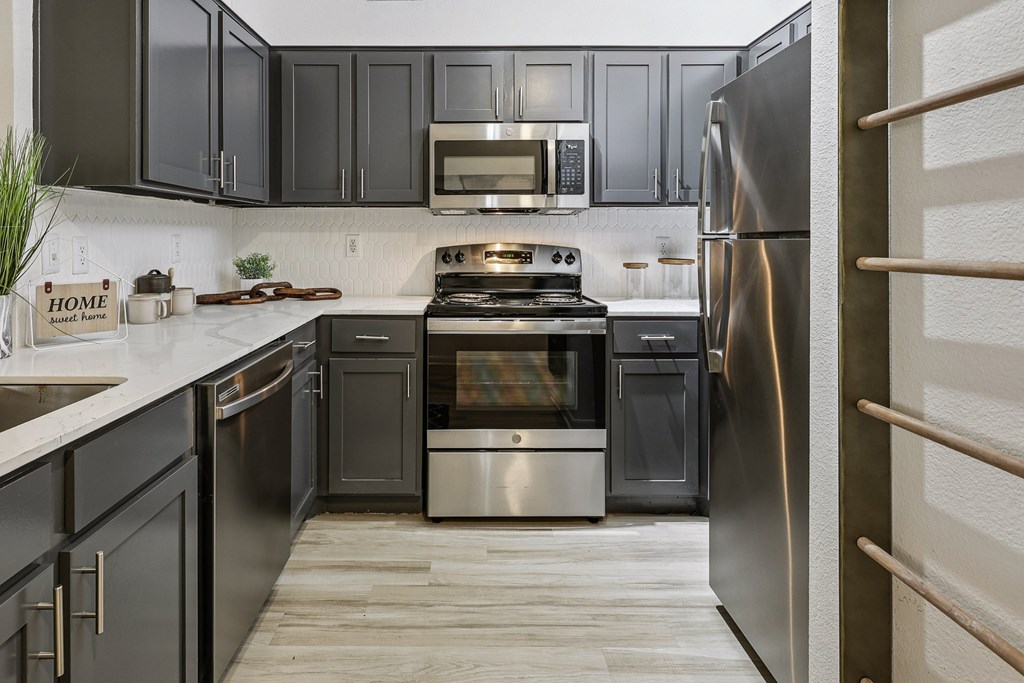 A kitchen with a stove, oven, and refrigerator.