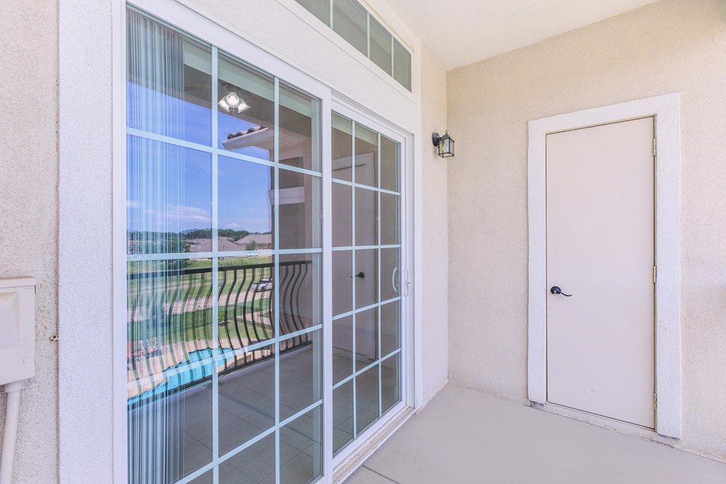 A white door is closed with a glass window above it.