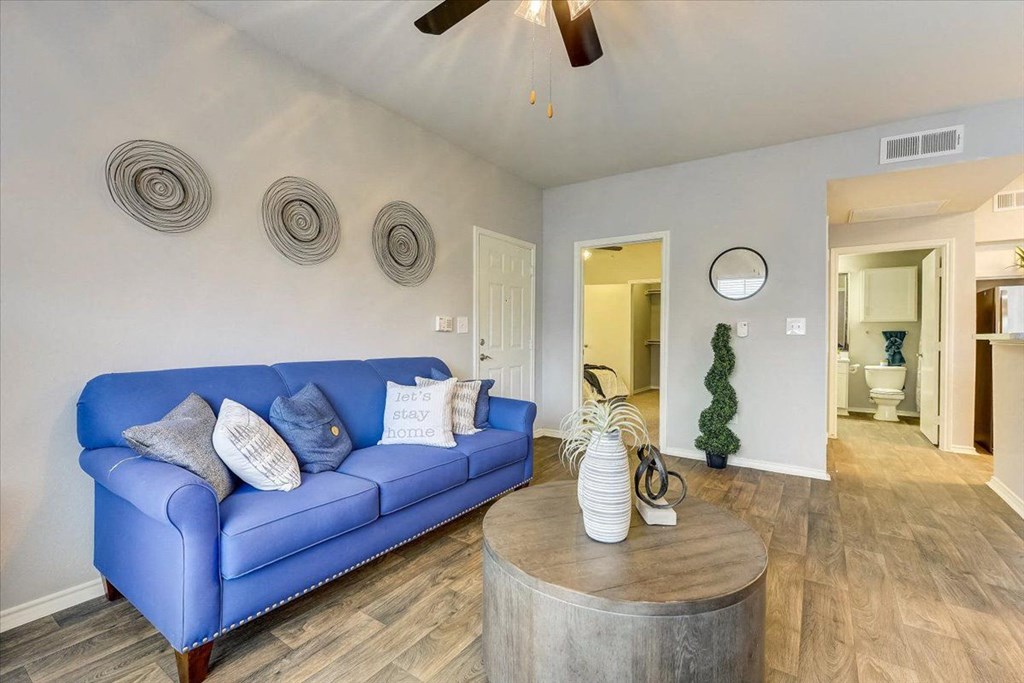 a living room with a blue couch and a coffee table