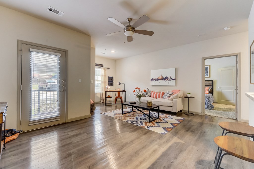 a living room with a couch and a ceiling fan