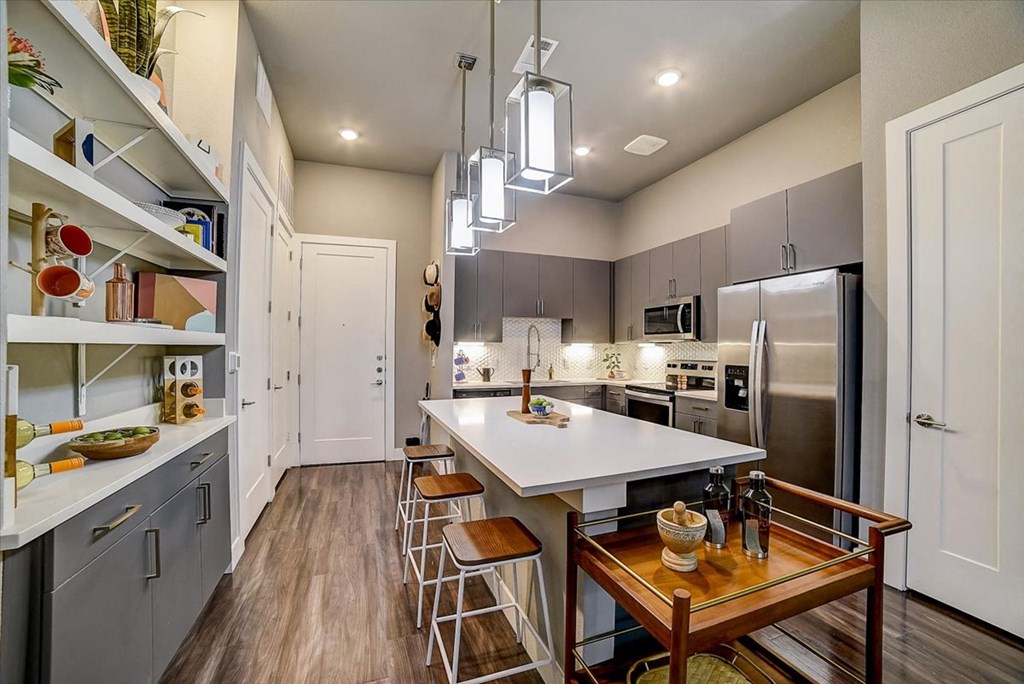 a kitchen with stainless steel appliances and a white counter top