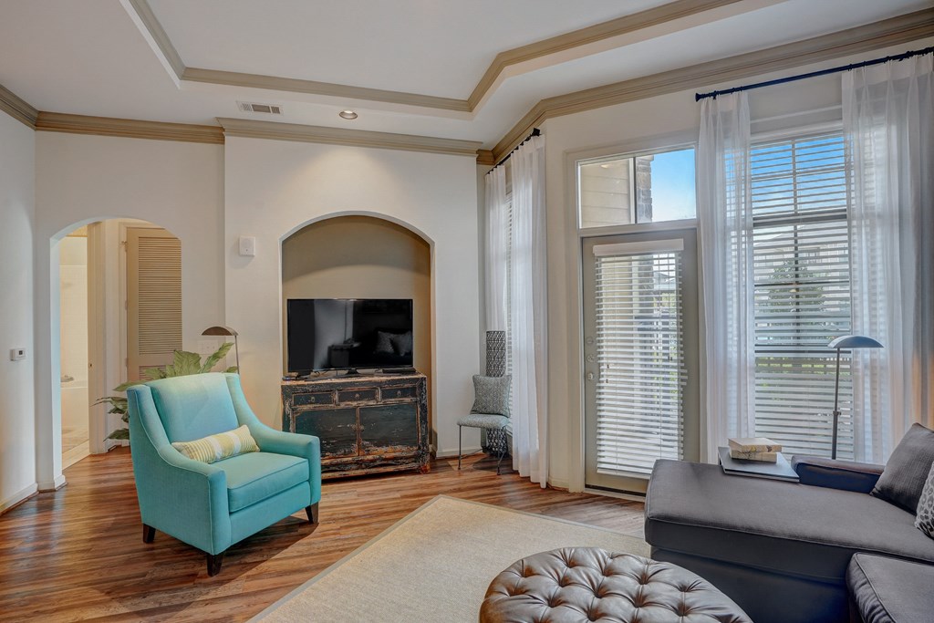 a living room with a couch and a chair and a fireplace