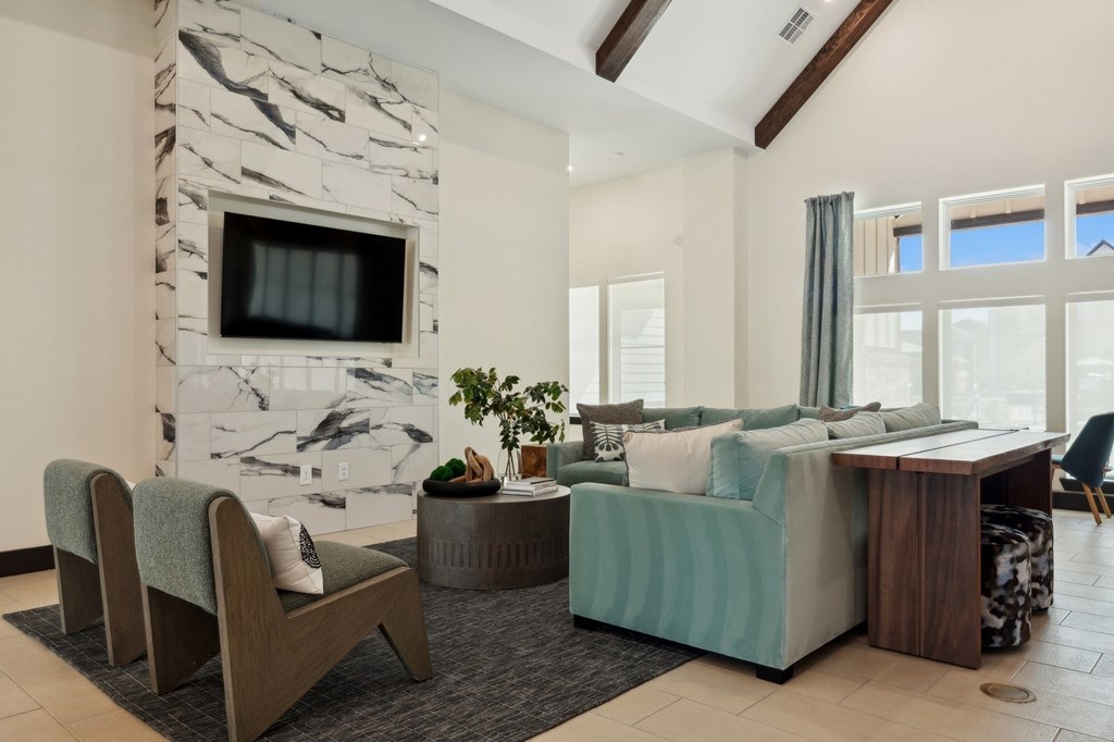 A living room with a stone fireplace and a couch.