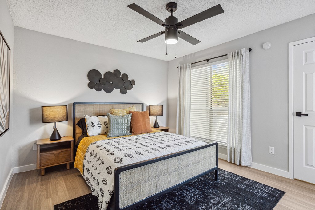 a bedroom with a bed and a ceiling fan