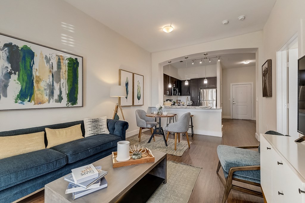 a living room with a couch and a table with chairs