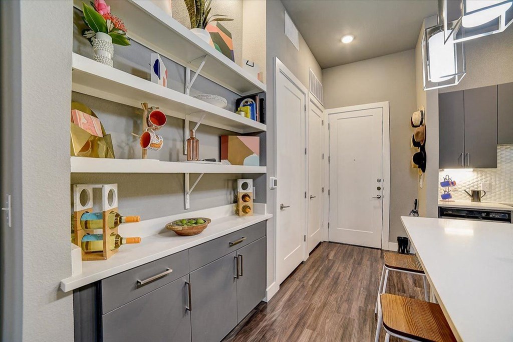 a renovated kitchen with gray cabinets and white counter tops