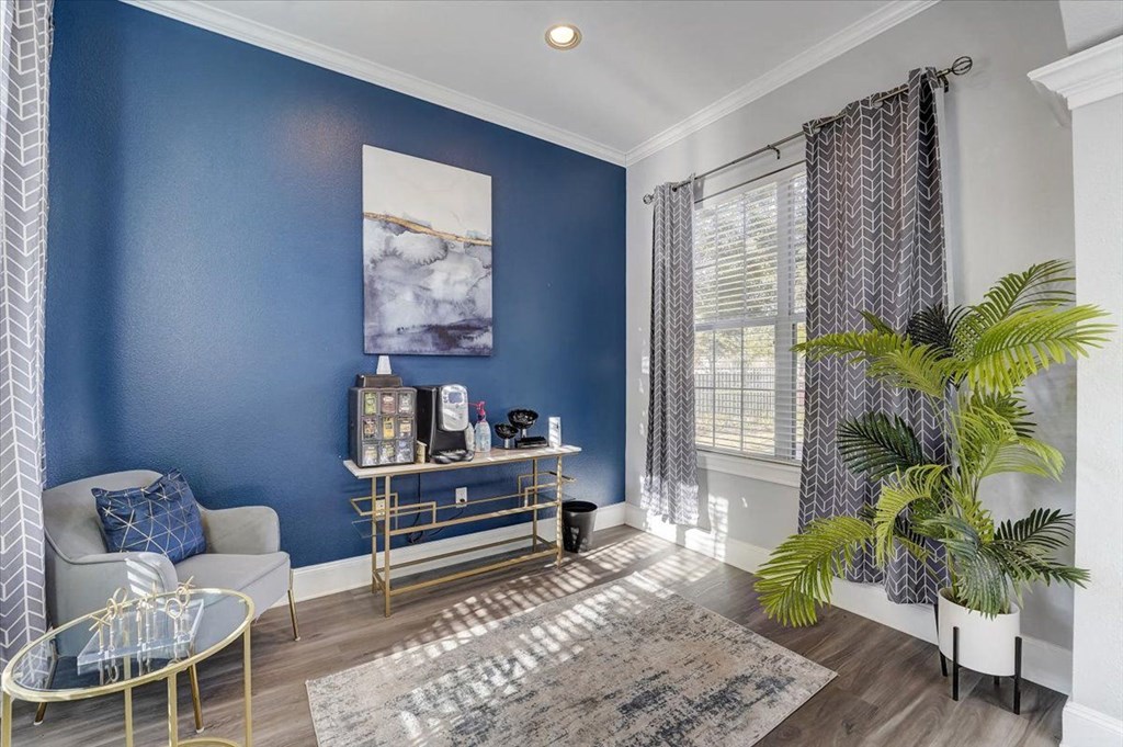 a living room with a blue wall and a window