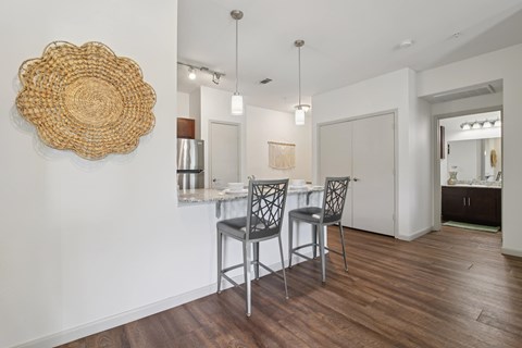 A dining room with a wooden table and chairs.