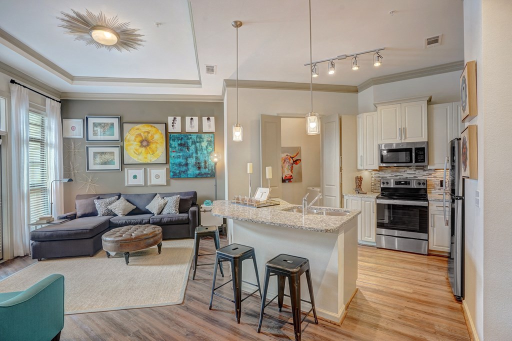 an open living room and kitchen with a bar and a counter top