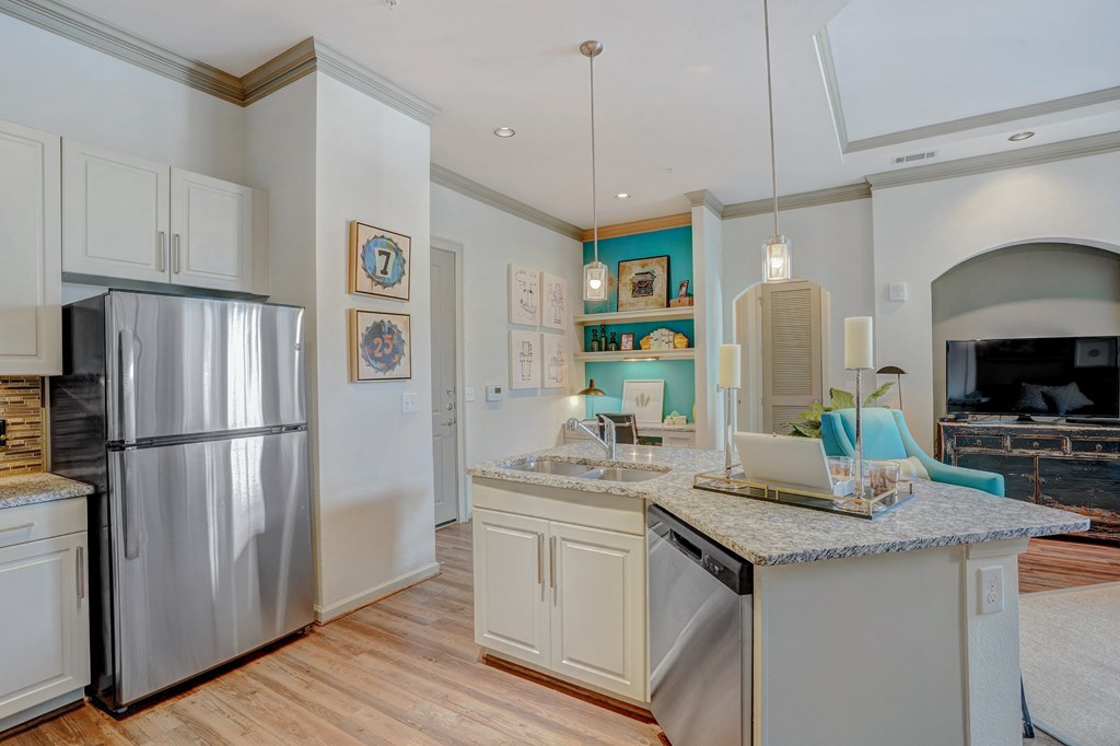 a kitchen with stainless steel appliances and a granite counter top