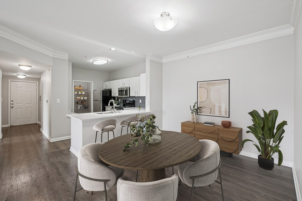 A dining room with a wooden table and chairs.