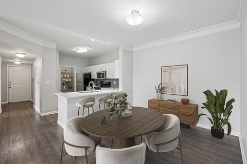 A dining room with a wooden table and chairs.
