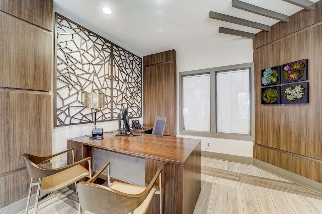 a home office with a wooden desk and two chairs