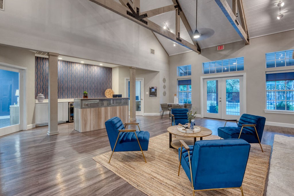 a living room with blue chairs and a table