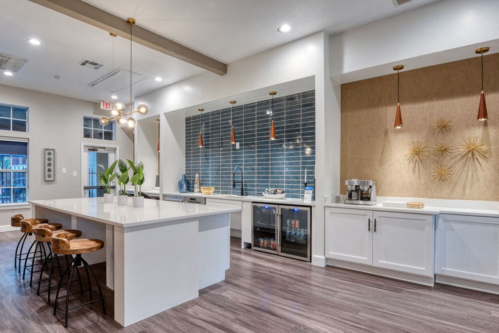 a kitchen with a large counter top and some stools