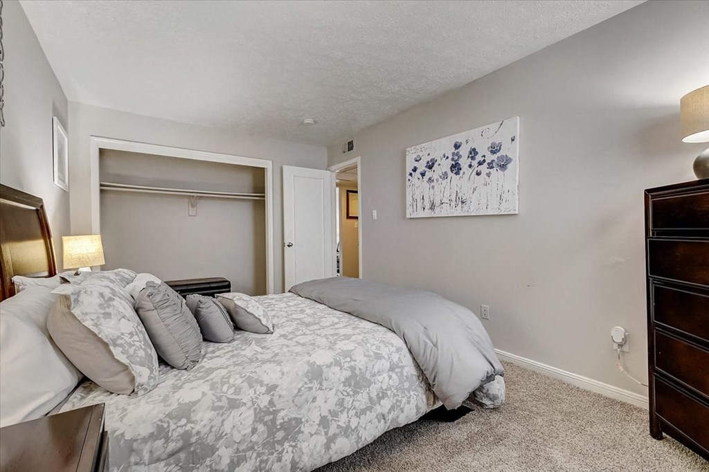 a bedroom with a bed and a closet