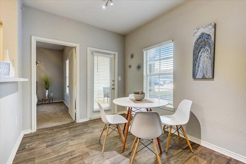 a dining room with a table and chairs