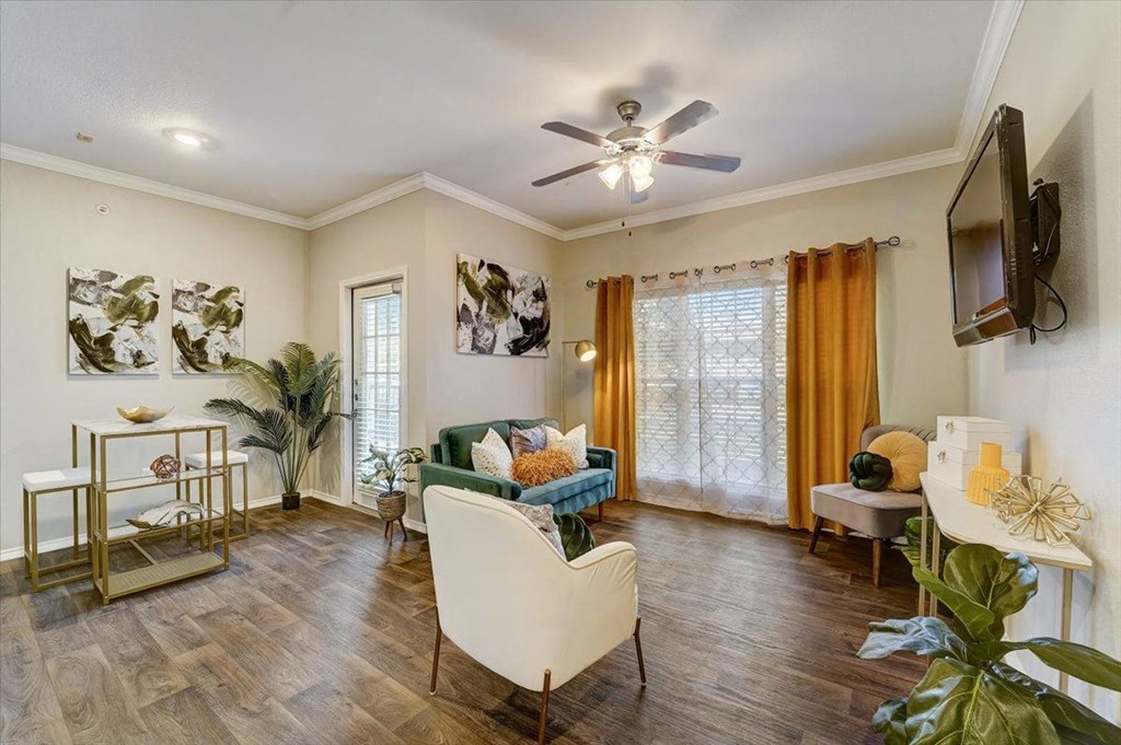 a living room with a couch and a ceiling fan
