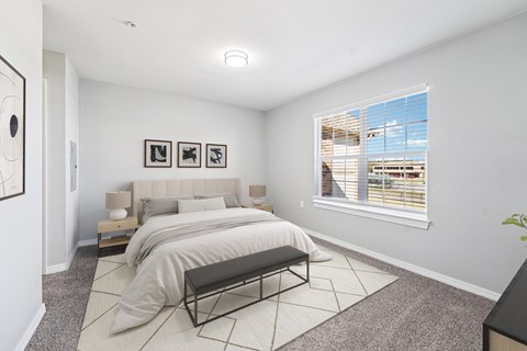 A bedroom with a large bed and a bench in front of it.